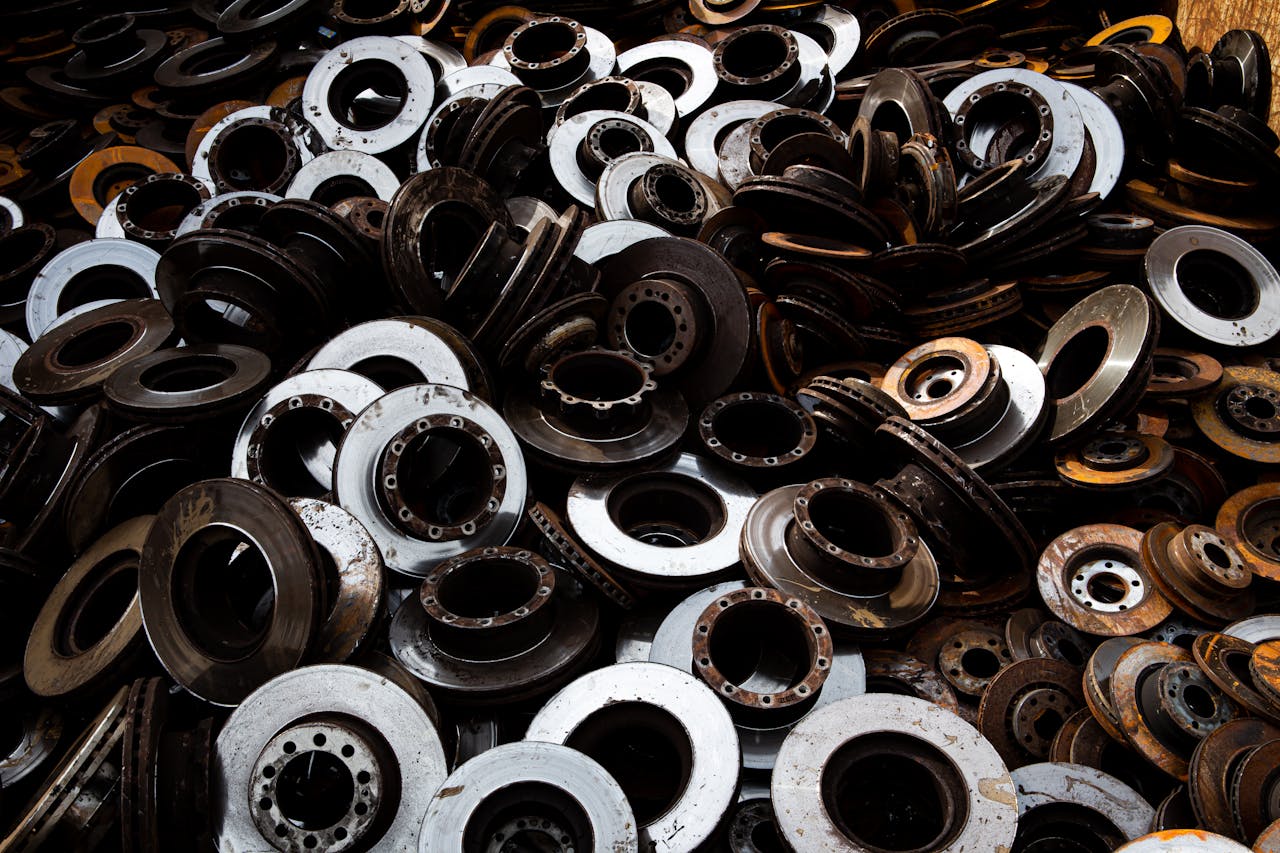 A pile of recycled metal brake discs showcasing industrial recycling.